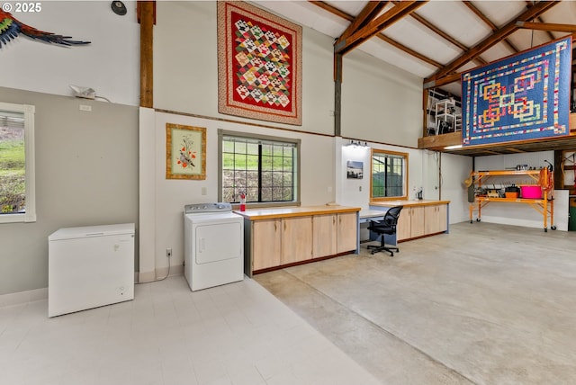 laundry room with washer / clothes dryer, cabinet space, plenty of natural light, and a towering ceiling