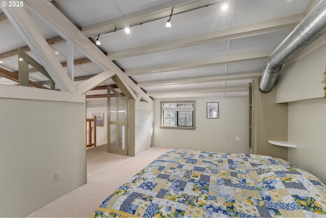 carpeted bedroom with rail lighting and beamed ceiling