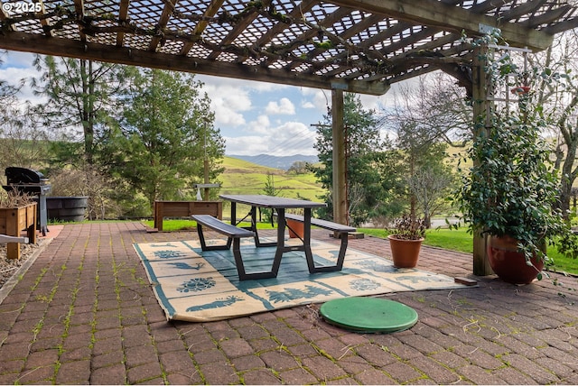 view of patio featuring a mountain view and a pergola