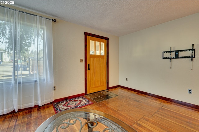 entrance foyer with wood-type flooring and a textured ceiling