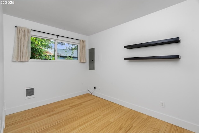 100 NE 78th Ave, Portland, OR 97213 - unfurnished room with electric panel, baseboards, wood finished floors, and heating unit