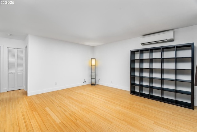 100 NE 78th Ave, Portland, OR 97213 - spare room featuring an AC wall unit, wood finished floors, and baseboards