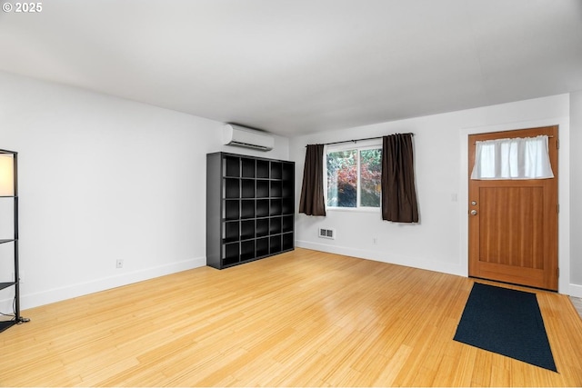 100 NE 78th Ave, Portland, OR 97213 - foyer entrance with a wall mounted AC, wood finished floors, and baseboards