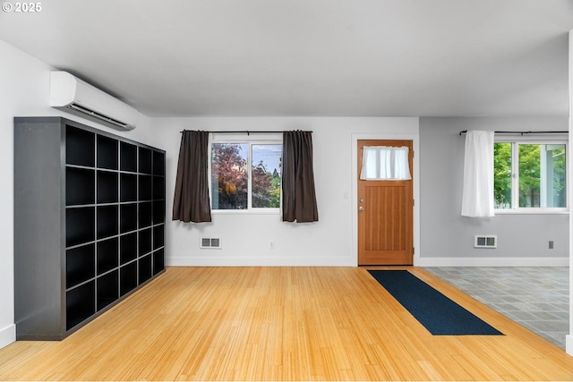 100 NE 78th Ave, Portland, OR 97213 - foyer with a wall mounted air conditioner, wood finished floors, and baseboards