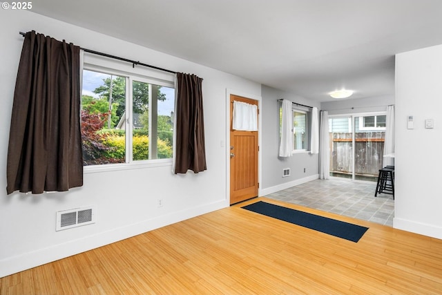 100 NE 78th Ave, Portland, OR 97213 - foyer featuring baseboards, wood finished floors, and plenty of natural light