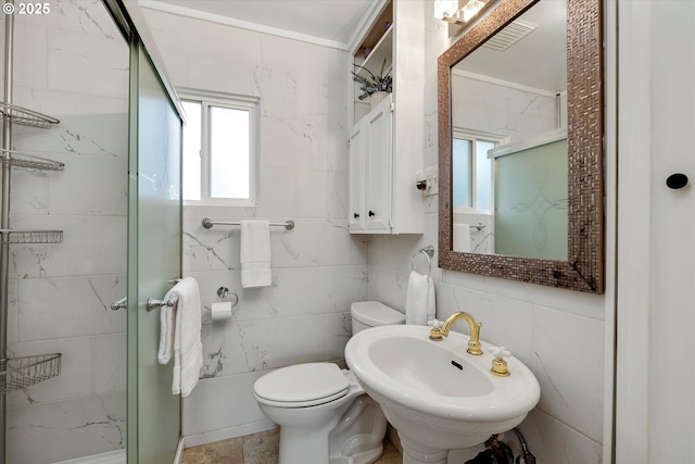 bathroom featuring toilet, a sink, visible vents, tile walls, and a shower stall