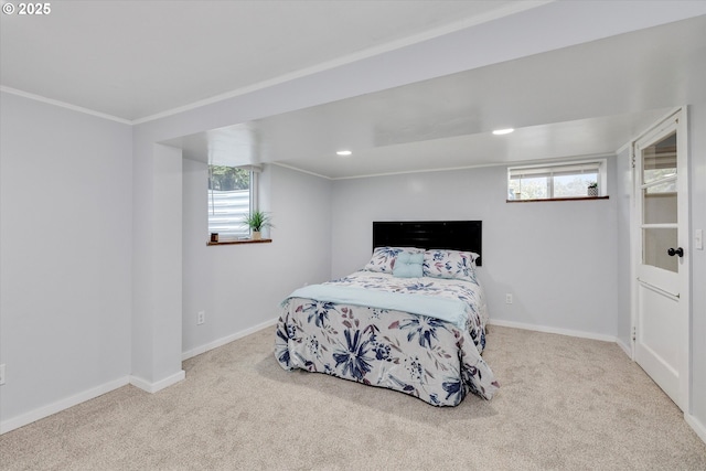 bedroom with light carpet, multiple windows, and baseboards