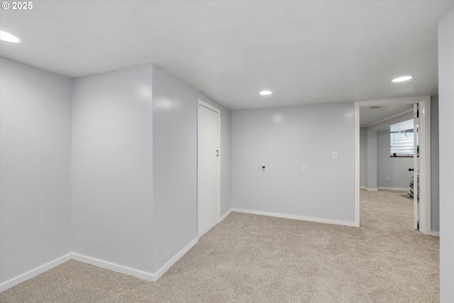 below grade area featuring baseboards, recessed lighting, and light colored carpet