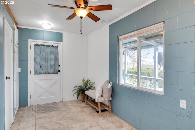 entrance foyer featuring a ceiling fan and crown molding