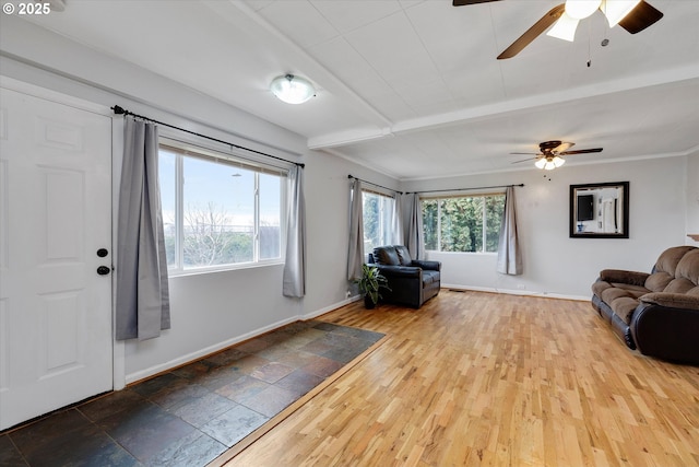 entryway featuring beamed ceiling, light wood finished floors, and baseboards