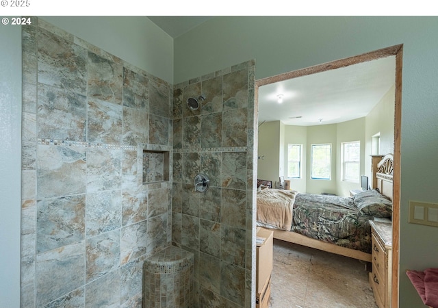 bathroom featuring a tile shower and ensuite bathroom