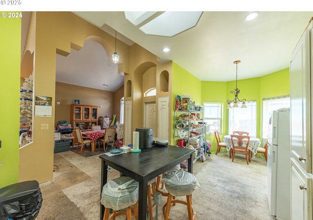 dining area with lofted ceiling, arched walkways, and recessed lighting