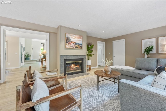 17221 SW Oakenshield Ct, Portland, OR 97224 - living room with light wood-style flooring, a fireplace with flush hearth, and recessed lighting