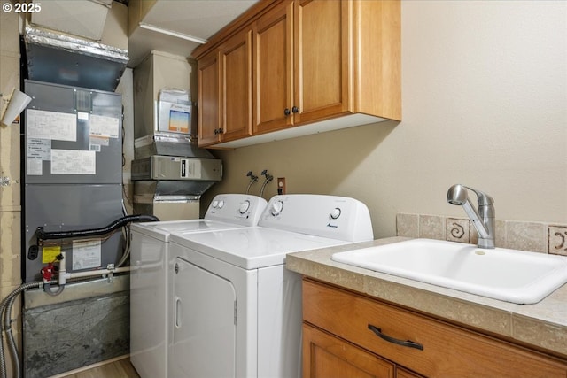 17221 SW Oakenshield Ct, Portland, OR 97224 - laundry room with washer and clothes dryer, cabinet space, and heating unit