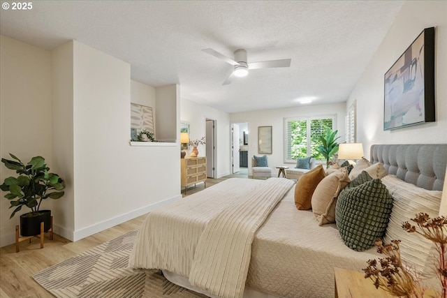 17221 SW Oakenshield Ct, Portland, OR 97224 - bedroom featuring light wood-type flooring, a textured ceiling, and ceiling fan