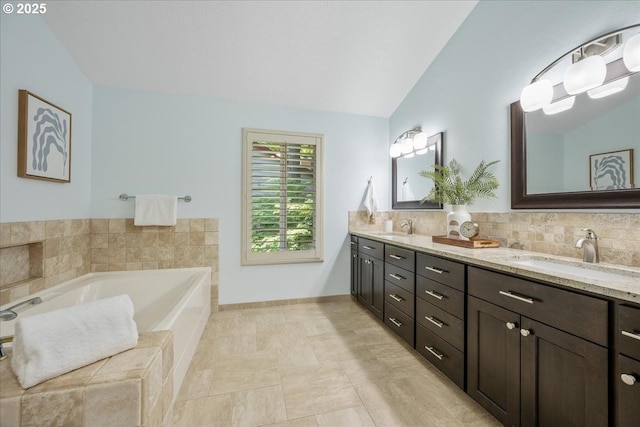17221 SW Oakenshield Ct, Portland, OR 97224 - full bath with lofted ceiling, double vanity, a bath, and tasteful backsplash
