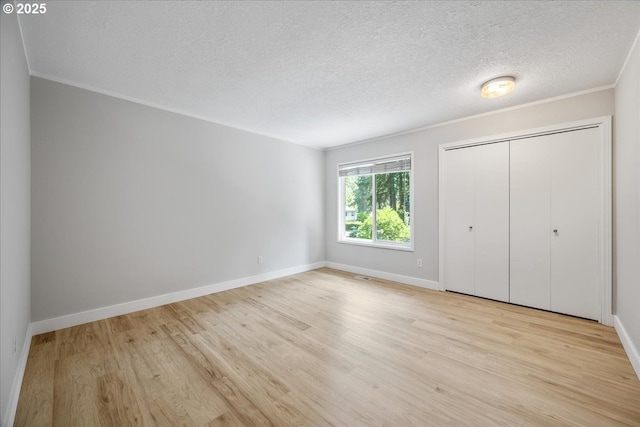 17221 SW Oakenshield Ct, Portland, OR 97224 - unfurnished bedroom with light wood-type flooring, a textured ceiling, a closet, and ornamental molding