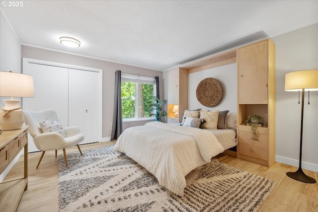 17221 SW Oakenshield Ct, Portland, OR 97224 - bedroom featuring crown molding, light wood-style flooring, and a closet