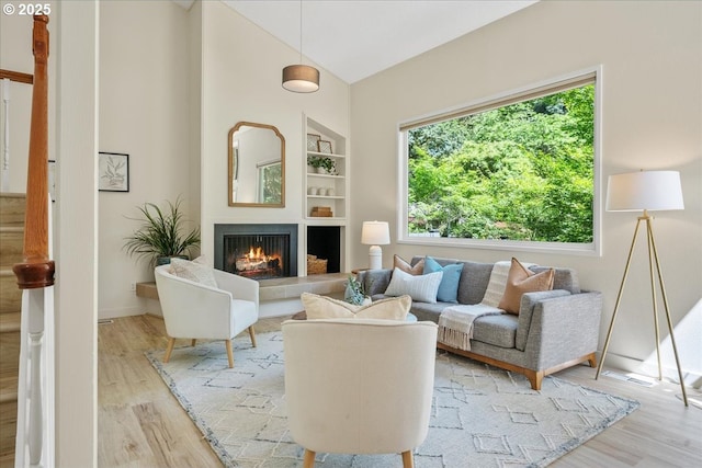 17221 SW Oakenshield Ct, Portland, OR 97224 - living area featuring light wood finished floors, a tile fireplace, and vaulted ceiling
