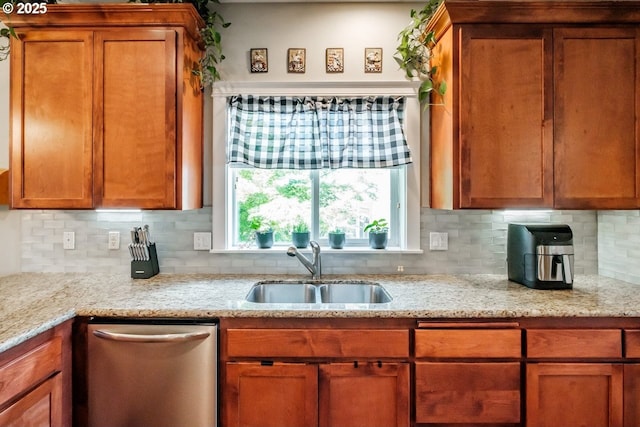 kitchen featuring sink, stainless steel dishwasher, light stone counters, and decorative backsplash