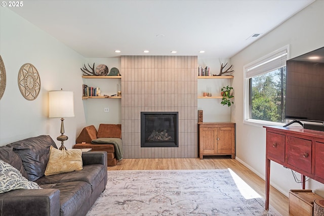 14955 Profitt Loop, Baker City, OR 97814 - living area featuring light wood-style floors, a tiled fireplace, and recessed lighting