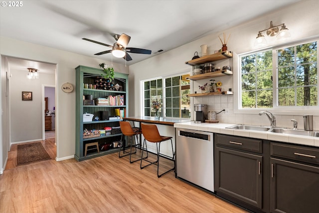 14955 Profitt Loop, Baker City, OR 97814 - kitchen featuring stainless steel dishwasher, tile counters, open shelves, ceiling fan, and light wood-style floors