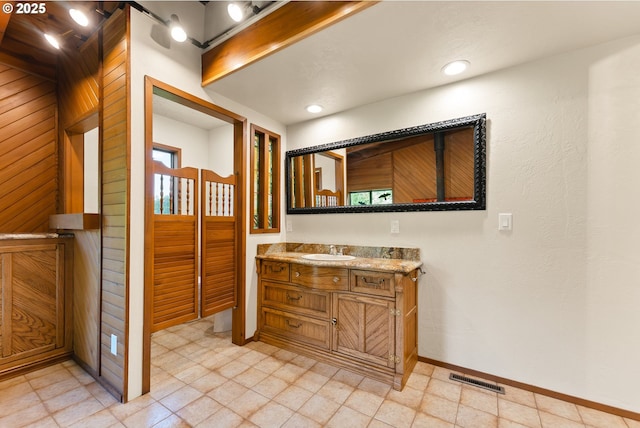 bathroom with vanity, baseboards, and visible vents