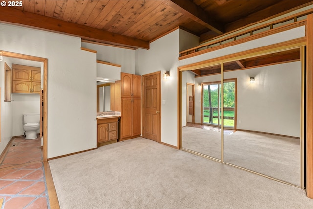 unfurnished bedroom featuring wood ceiling, access to outside, beamed ceiling, and baseboards