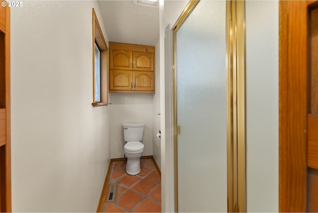 full bath featuring toilet, tile patterned floors, visible vents, and a stall shower