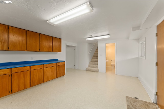 finished below grade area with light floors and stairs