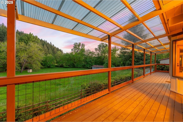 wooden terrace with a lawn and a pergola