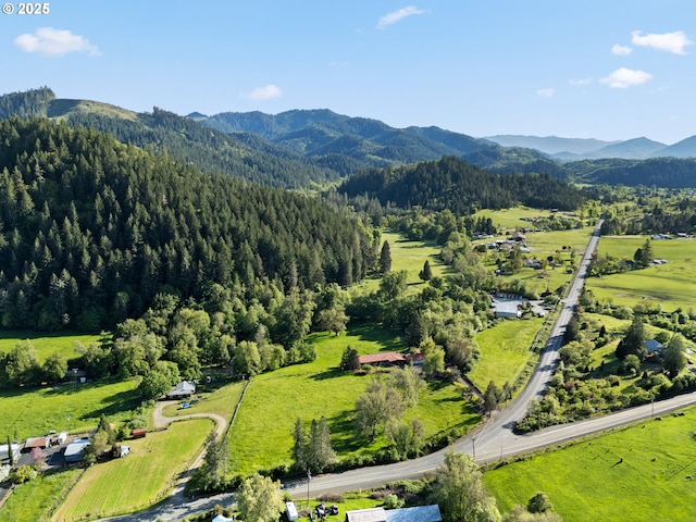 aerial view with a mountain view and a forest view