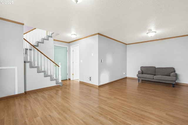 unfurnished living room with hardwood / wood-style flooring, a textured ceiling, and crown molding