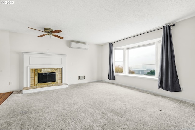 unfurnished living room with a fireplace, a textured ceiling, ceiling fan, and a wall mounted air conditioner