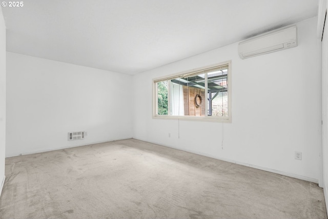 spare room featuring carpet and a wall mounted air conditioner