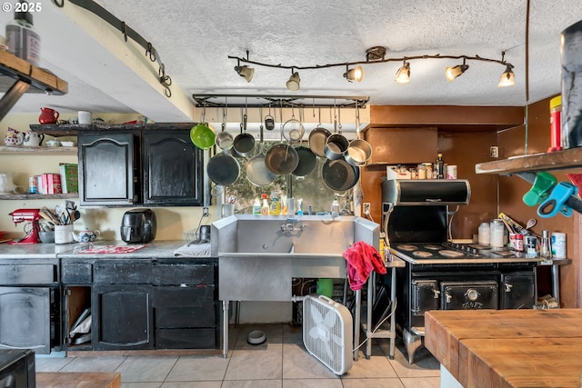 6596 River Rd, Salem, OR 97306 - kitchen featuring light tile patterned floors and a textured ceiling