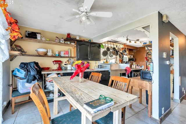 6596 River Rd, Salem, OR 97306 - dining room featuring light tile patterned flooring, ceiling fan, baseboards, and a textured ceiling