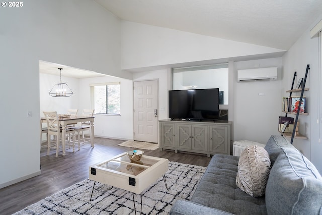 2024 Lake Isle Dr Unit 2024, Eugene, OR 97401 - living room with a wall unit AC, a chandelier, wood finished floors, and high vaulted ceiling