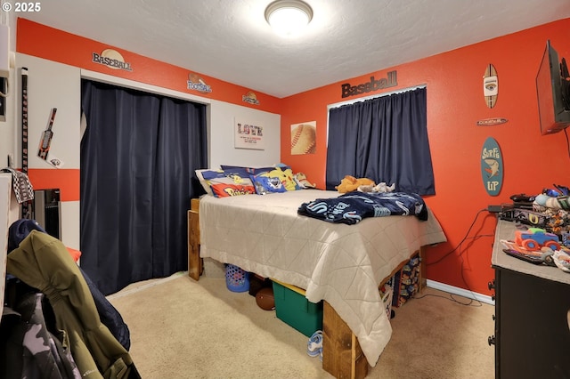 bedroom with carpet flooring and a textured ceiling