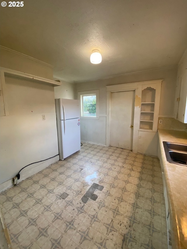 1412 5th St, Tillamook, OR 97141 - kitchen with freestanding refrigerator, light countertops, light floors, and a sink