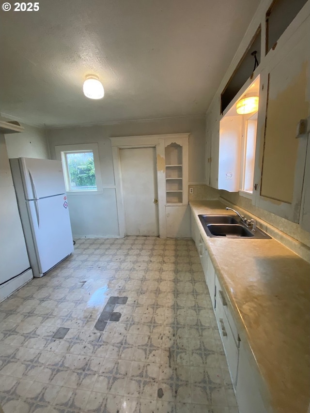 1412 5th St, Tillamook, OR 97141 - kitchen featuring freestanding refrigerator, light floors, light countertops, and a sink