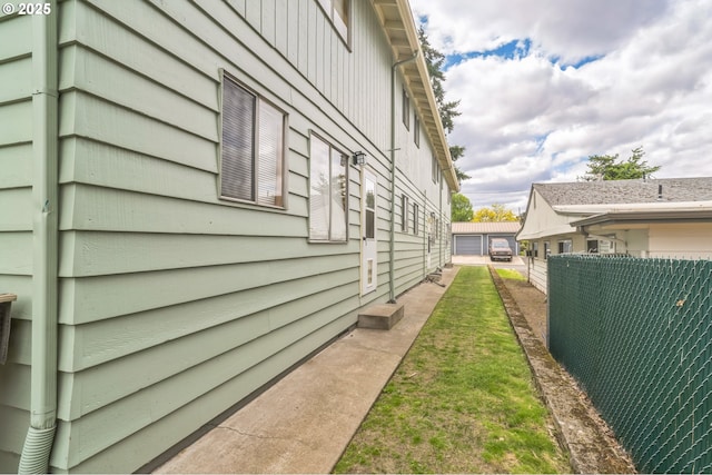 view of side of home featuring fence