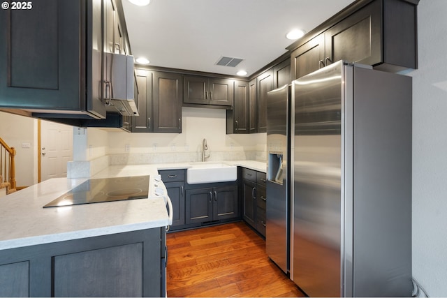 7501 NE 51st Way, Vancouver, WA 98662 - kitchen featuring stainless steel refrigerator with ice dispenser, a sink, wood finished floors, and recessed lighting