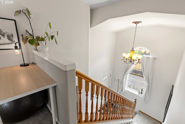 staircase featuring carpet and a notable chandelier