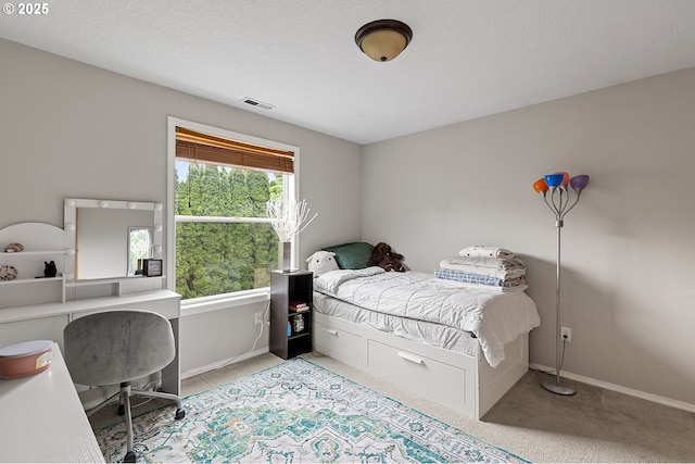 bedroom featuring visible vents, baseboards, and light colored carpet