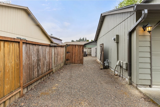 view of side of property with fence and a gate