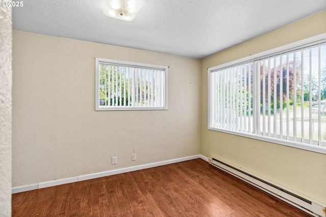 2386 Clear Vue Ln, Springfield, OR 97477 - spare room featuring a baseboard radiator, wood finished floors, and baseboards