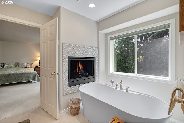 4710 SW Joshua St, Tualatin, OR 97062 - bathroom with a freestanding tub, ensuite bathroom, and a fireplace
