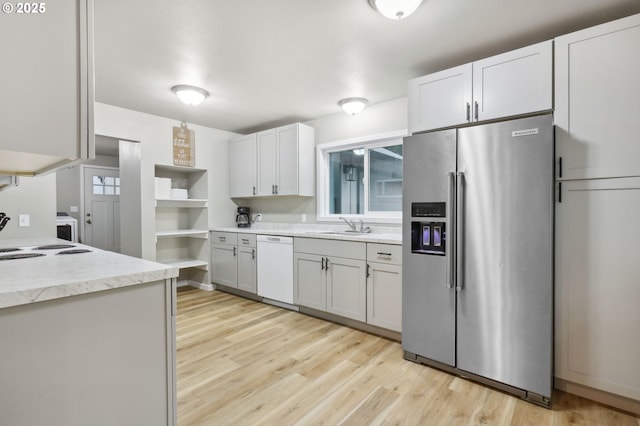 23595 E Lolo Pass Rd, Rhododendron, OR 97049 - kitchen with stainless steel fridge with ice dispenser, dishwasher, light wood-type flooring, and a sink