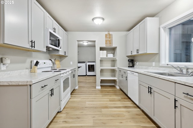 23595 E Lolo Pass Rd, Rhododendron, OR 97049 - kitchen with white appliances, a sink, independent washer and dryer, light wood finished floors, and light countertops